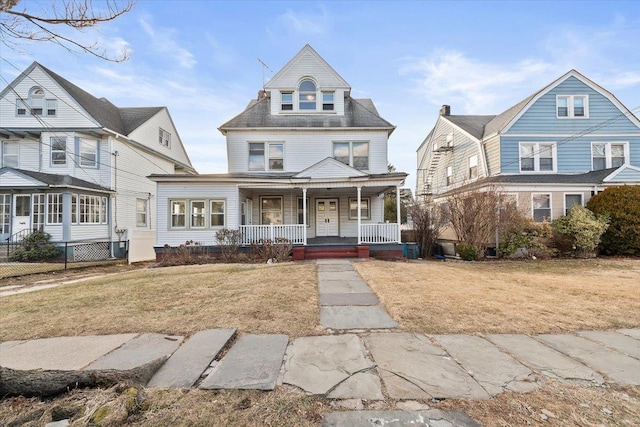 view of front of home with a porch and a front lawn