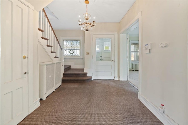 doorway with radiator, a chandelier, and dark colored carpet