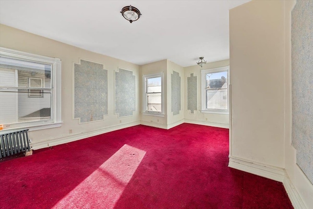 spare room with carpet floors and radiator