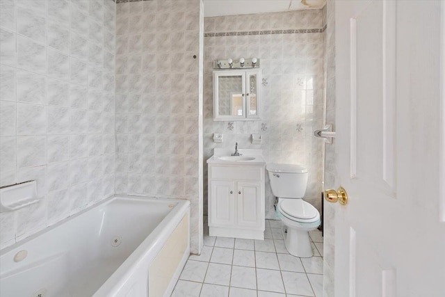 bathroom with tile patterned floors, toilet, tile walls, and vanity