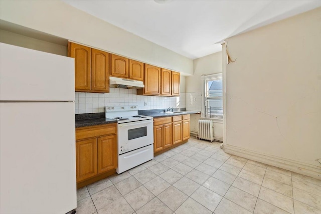 kitchen featuring radiator, white appliances, sink, light tile patterned floors, and tasteful backsplash