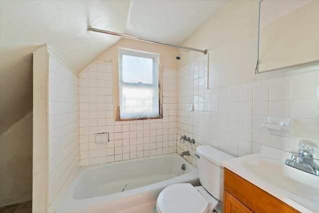 full bathroom with vaulted ceiling, tile walls, tiled shower / bath combo, vanity, and toilet