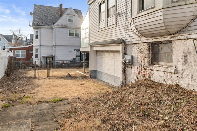 back of house featuring a garage