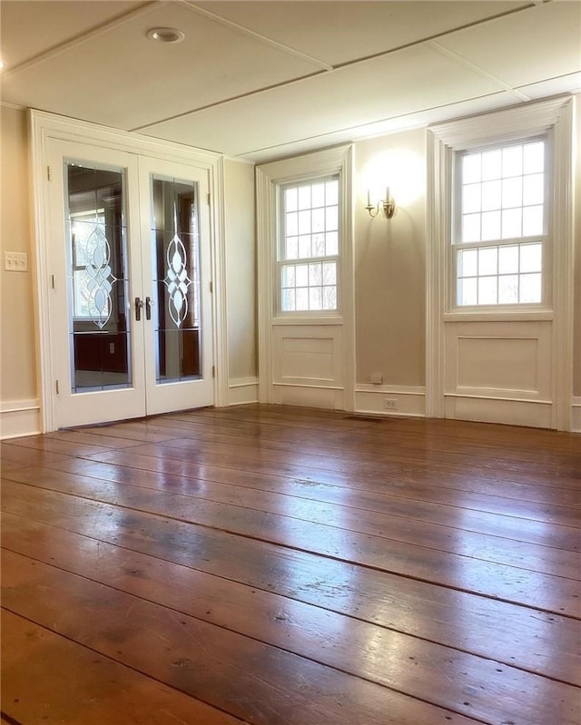 entryway with french doors, plenty of natural light, and hardwood / wood-style floors