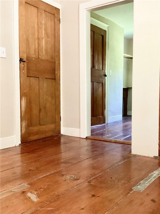 hall with hardwood / wood-style flooring