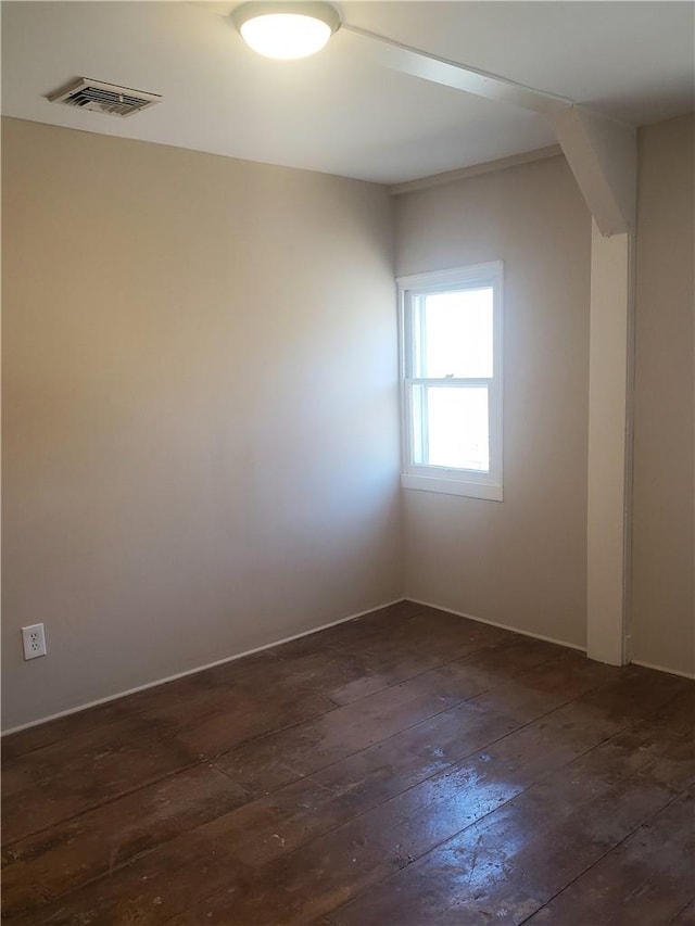 spare room featuring dark hardwood / wood-style floors