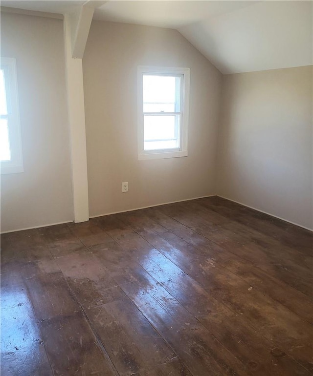 additional living space with dark wood-type flooring and vaulted ceiling