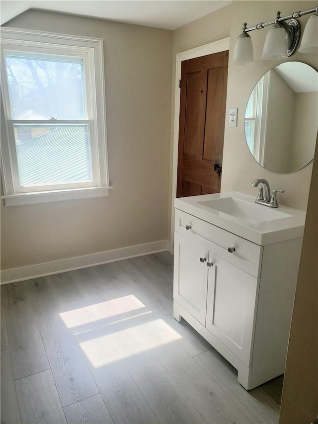 bathroom with hardwood / wood-style floors and vanity