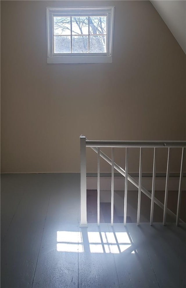 additional living space featuring lofted ceiling