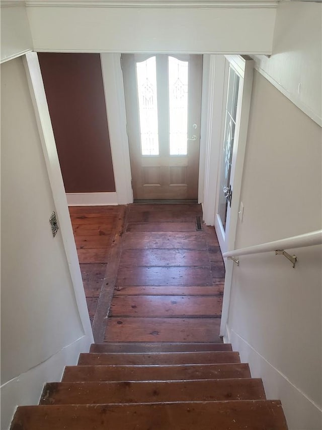 stairs featuring hardwood / wood-style flooring