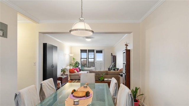 dining area featuring hardwood / wood-style flooring and crown molding