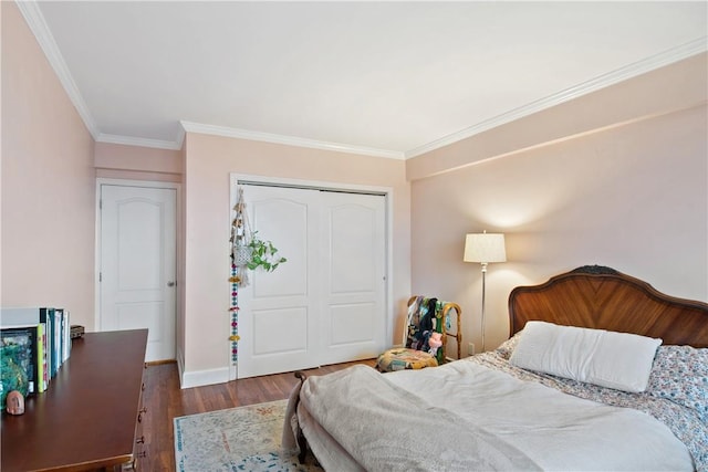 bedroom featuring wood-type flooring, a closet, and crown molding