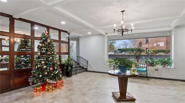 foyer featuring a notable chandelier, beam ceiling, a textured ceiling, and coffered ceiling
