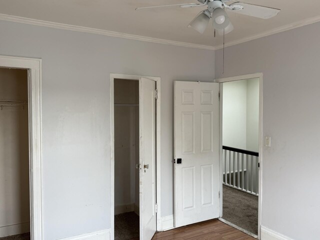 1246 Troy Ave, Brooklyn, NY 11203 - unfurnished bedroom with ornamental molding, two closets, wood finished floors, baseboards, and a ceiling fan