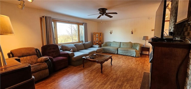 living room featuring ceiling fan and wood-type flooring