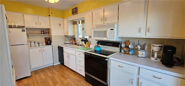 kitchen with sink, white cabinets, white appliances, and light wood-type flooring