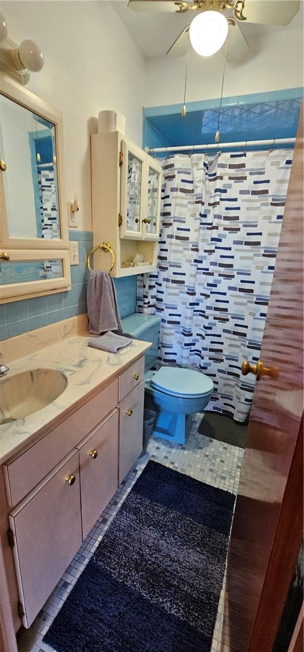 bathroom with tile patterned flooring, vanity, curtained shower, and tile walls