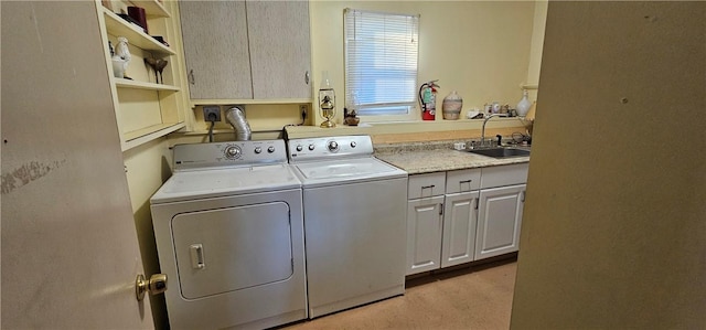 laundry area featuring cabinets, sink, light carpet, and washing machine and clothes dryer