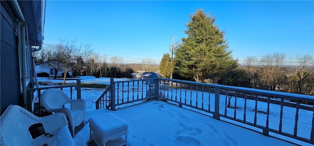 snow covered patio with a balcony