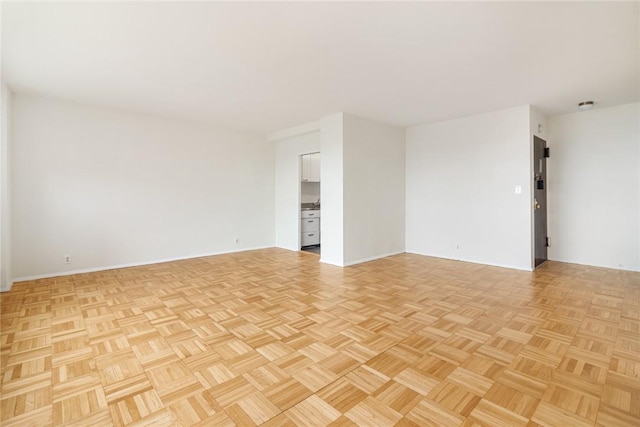 unfurnished room with light parquet flooring