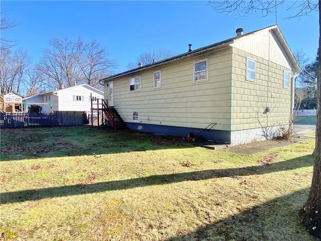 back of property featuring a yard