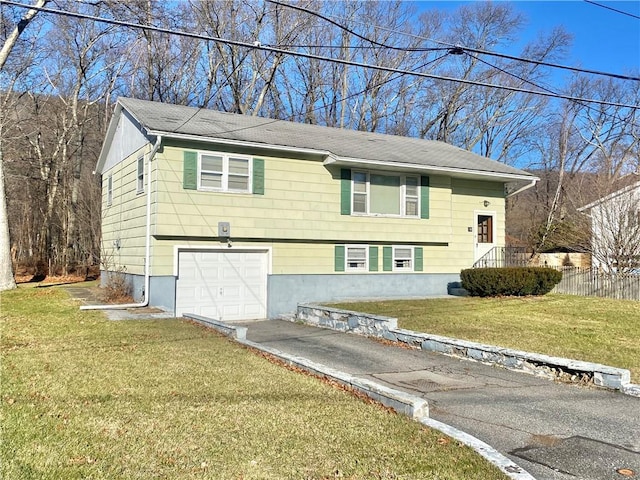 bi-level home featuring a front lawn and a garage