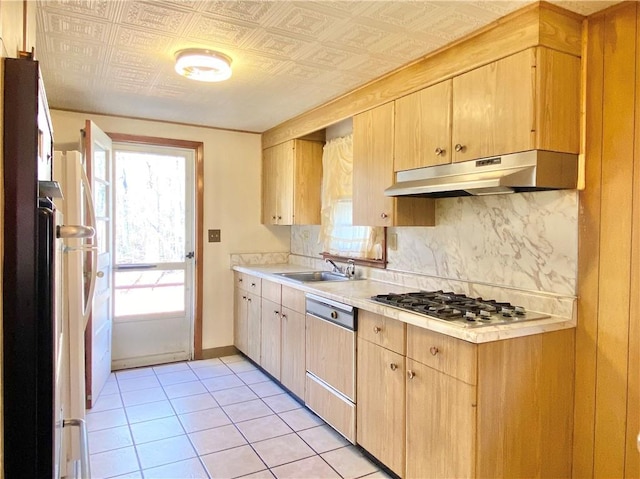 kitchen featuring decorative backsplash, appliances with stainless steel finishes, sink, light brown cabinets, and light tile patterned floors