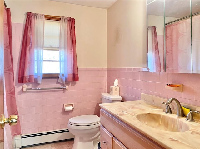 bathroom featuring vanity, a baseboard heating unit, tile patterned flooring, toilet, and tile walls