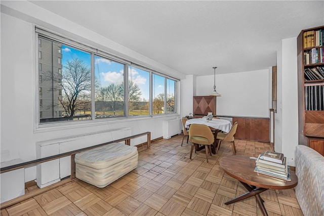 sunroom / solarium featuring radiator heating unit