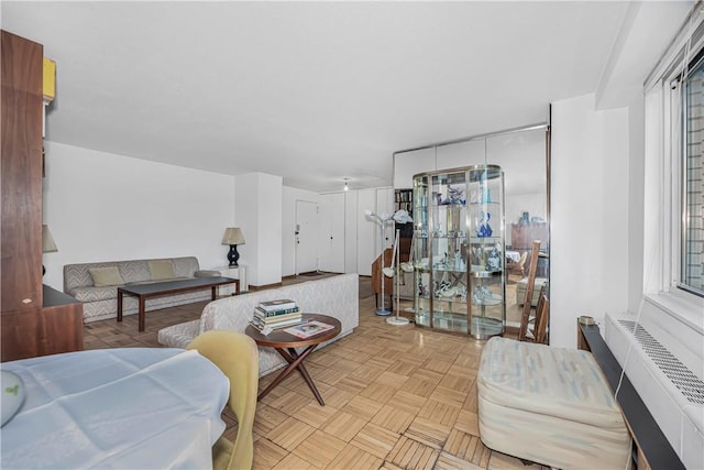 living room featuring radiator and light parquet flooring