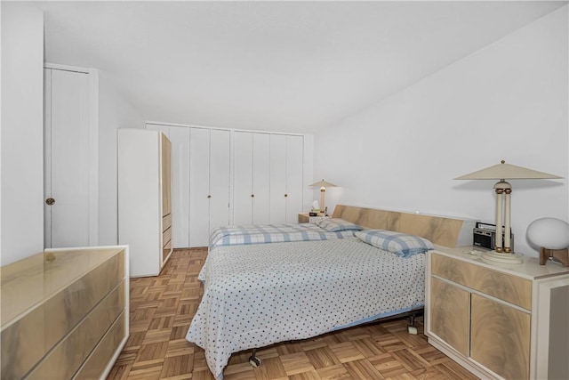 bedroom featuring light parquet flooring