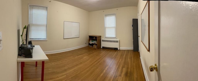 empty room with hardwood / wood-style floors and radiator