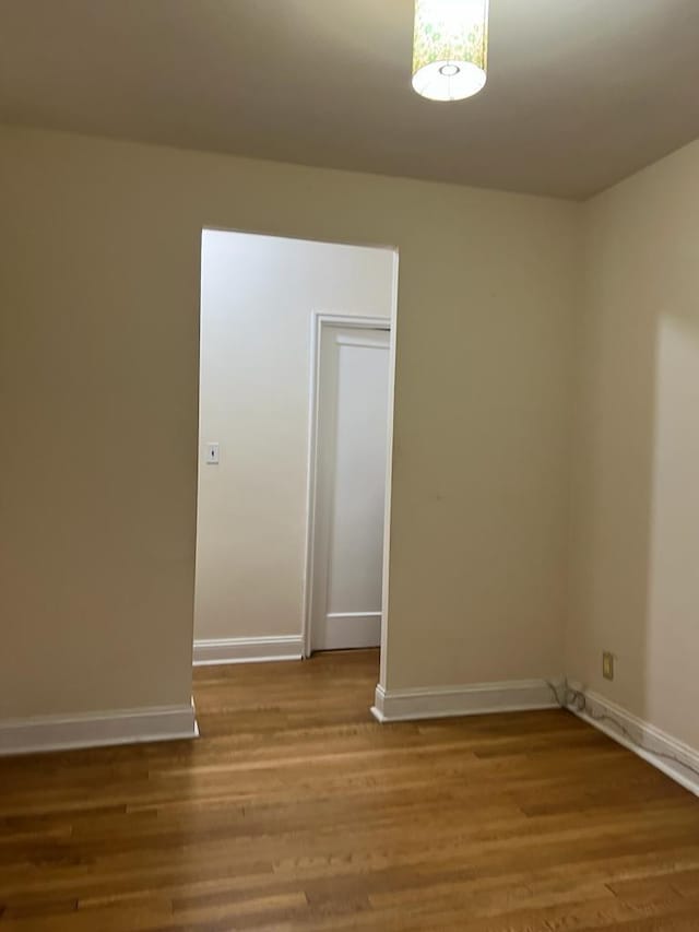 unfurnished room featuring hardwood / wood-style flooring