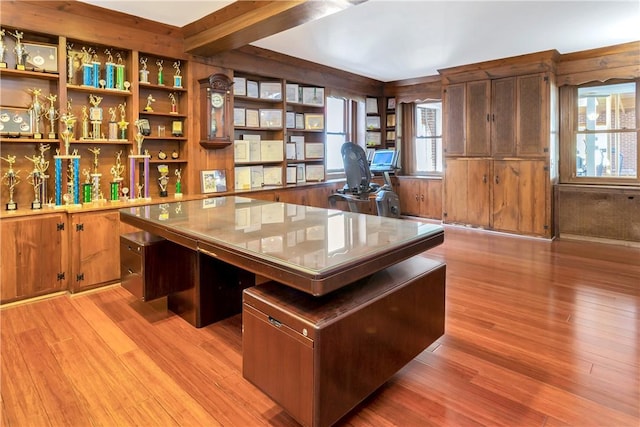 office space featuring beam ceiling and light hardwood / wood-style floors