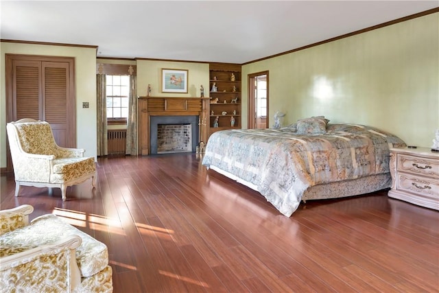 bedroom featuring ornamental molding, dark wood-type flooring, and radiator