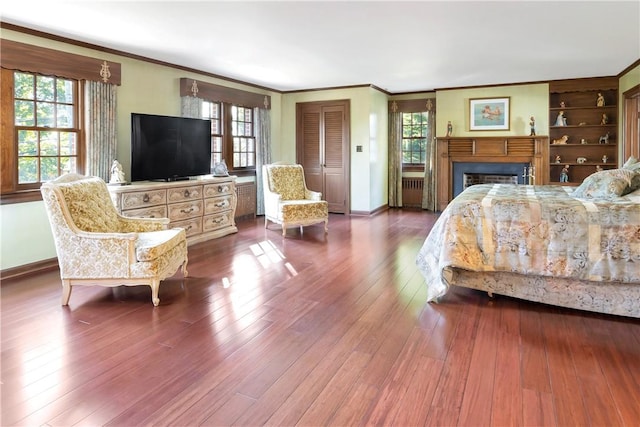 bedroom with crown molding, a closet, and wood-type flooring