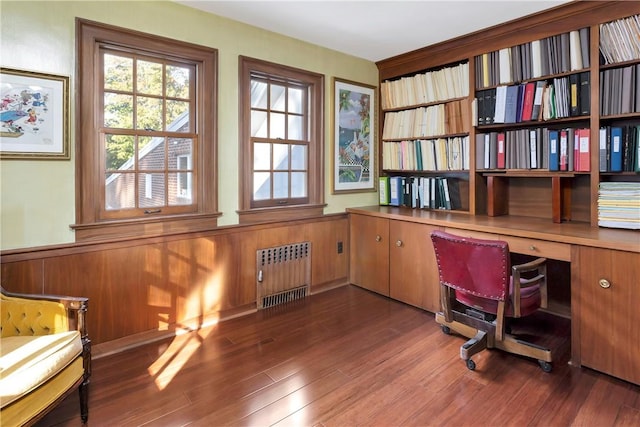 home office with radiator and dark wood-type flooring