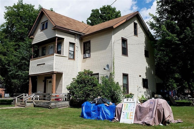 rear view of house with a lawn