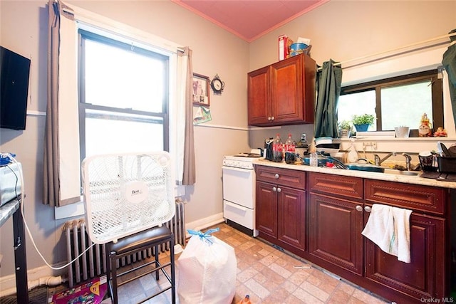 kitchen with white stove, radiator, ornamental molding, and sink