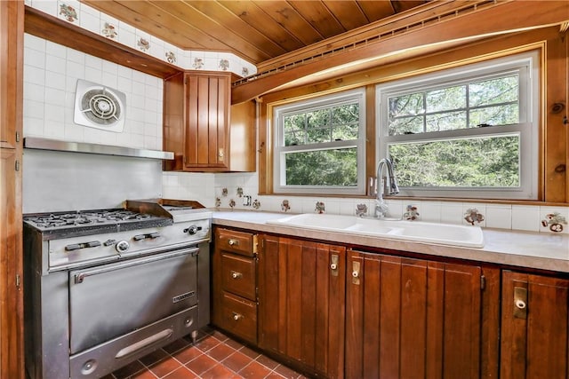 kitchen with backsplash, sink, dark tile patterned floors, and wooden ceiling