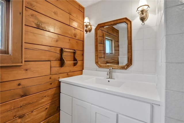 bathroom with vanity and wooden walls