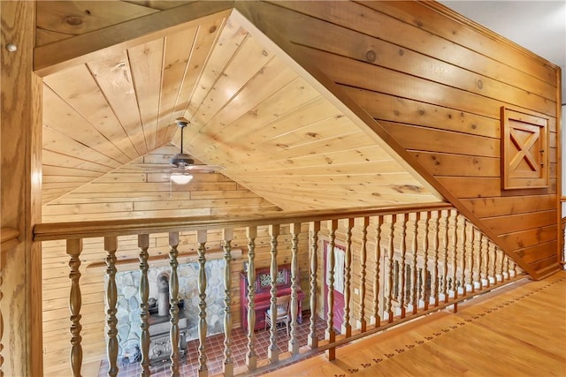 bonus room featuring ceiling fan, wood walls, wood-type flooring, lofted ceiling, and wood ceiling