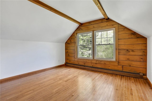 bonus room with light wood-type flooring, vaulted ceiling, a baseboard heating unit, and wood walls