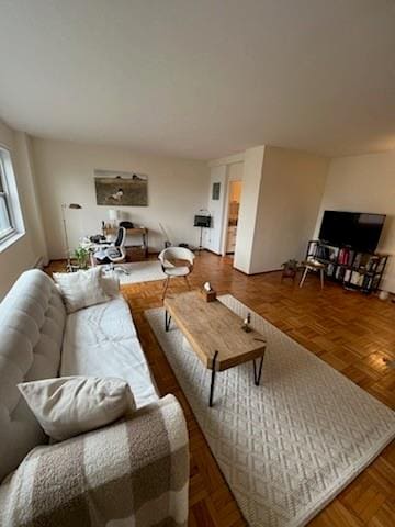 living room featuring parquet flooring