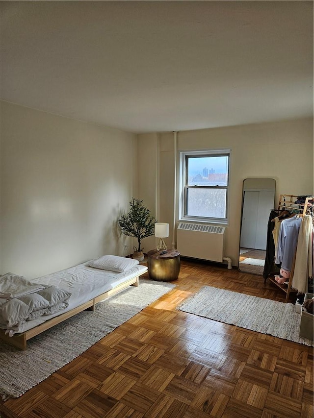 bedroom featuring dark parquet flooring and radiator