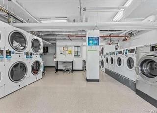 washroom featuring washer and clothes dryer and stacked washer / drying machine