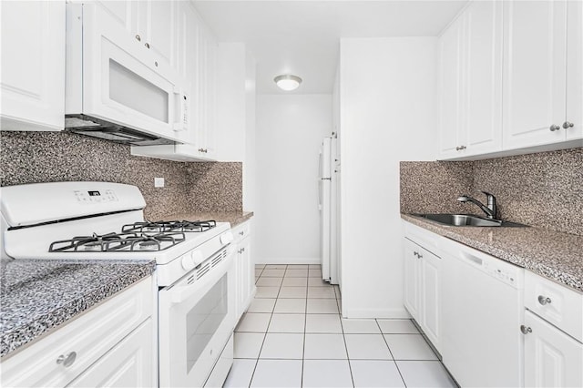 kitchen with white cabinetry, sink, backsplash, white appliances, and light tile patterned floors