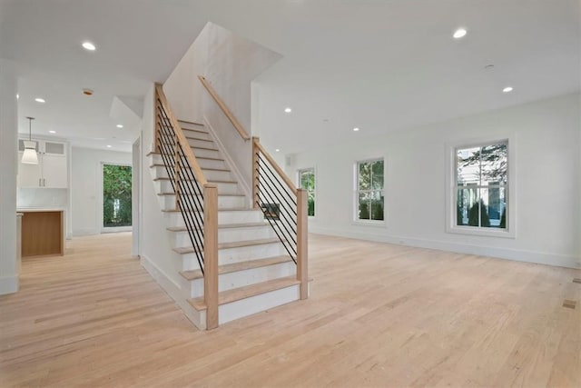 staircase with hardwood / wood-style flooring