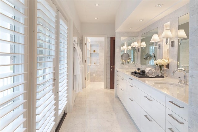 bathroom featuring vanity and tile walls