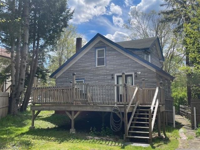 rear view of house with a yard and a wooden deck